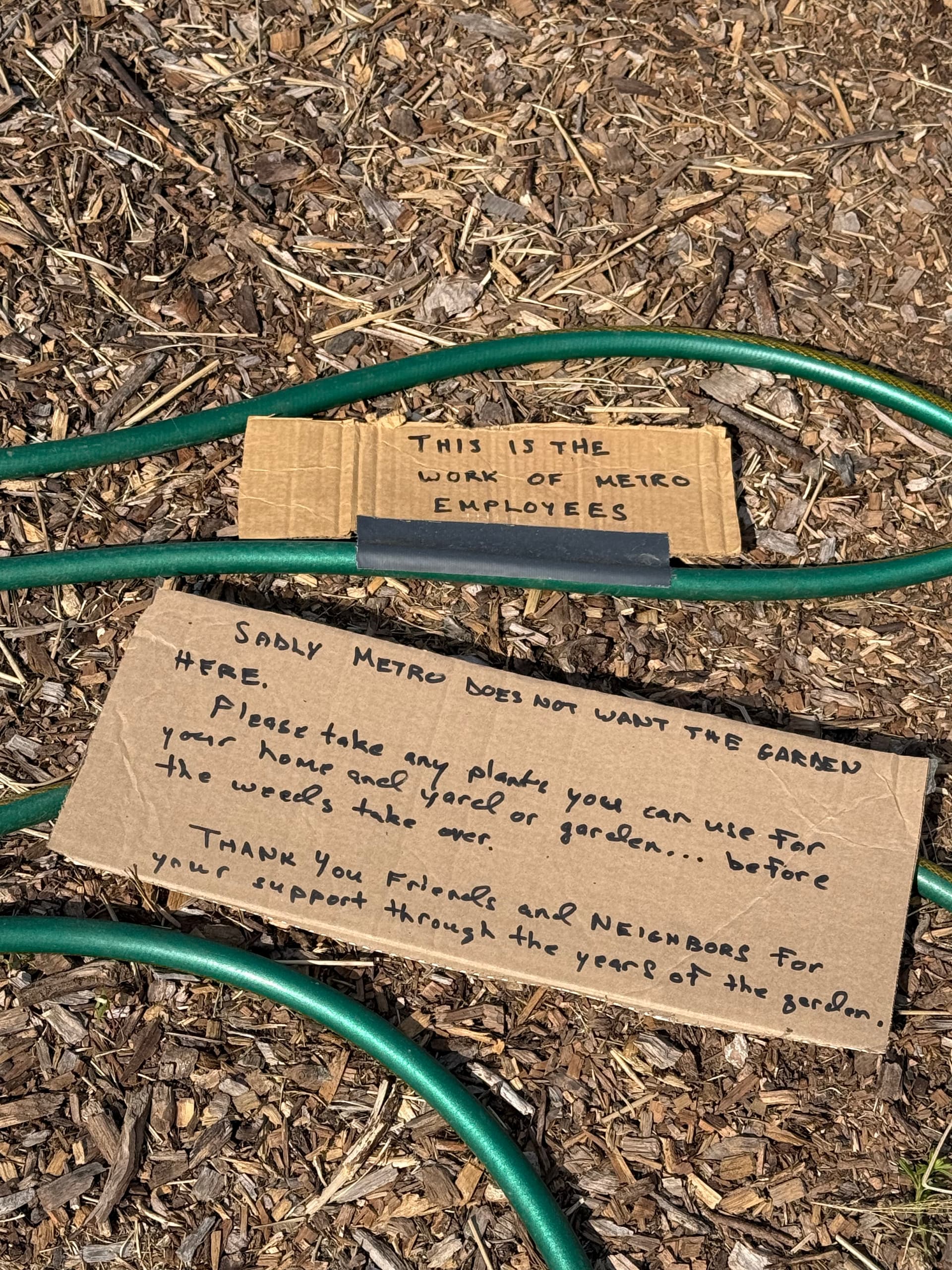 Cardboard signs and the cut water hose left by Michael